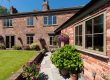 rural home with wood look flush sash windows - Ace Double Glazing